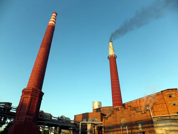 Black smoke coming up from the brick chimney