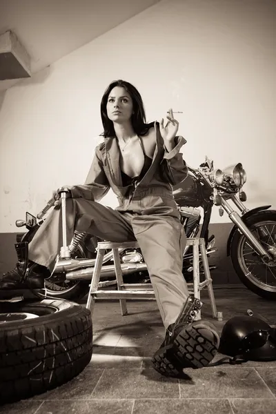 Sexy female mechanic in overalls