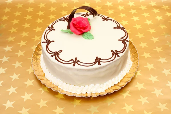 White cake on golden stars background