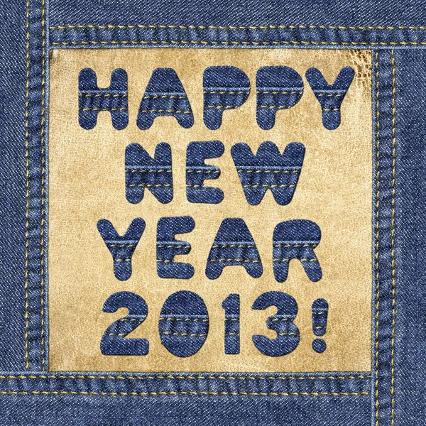 Holiday greeting - Happy New Year 2013! - made of denim letters in jeans frame on a leather label