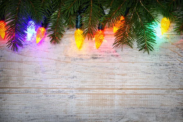 Christmas background with lights on branches