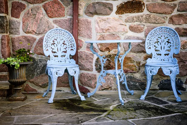Patio furniture against stone wall