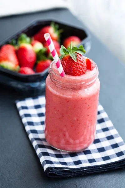 Fruit smoothie and strawberries