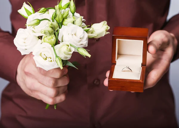 Holding ring box and a bouquet of flowers
