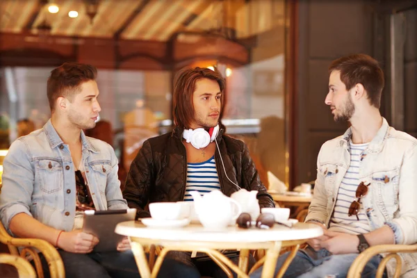 Two young hipster guy sitting in a cafe