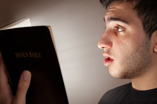 Man Reading Bible in Amazement