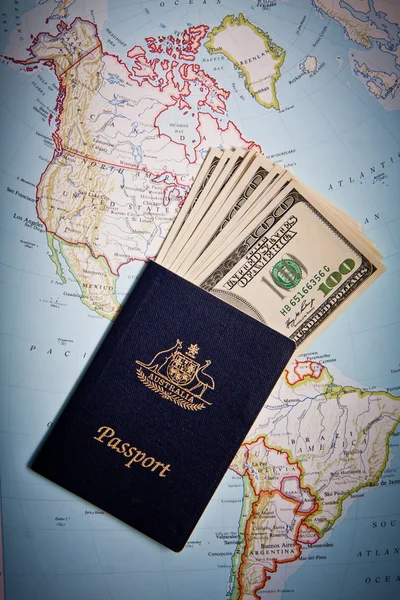 Australian passport and US banknotes with Map background