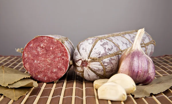 Salame with garlic and laurel leaves