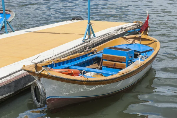 Small wooden motor boat moored up