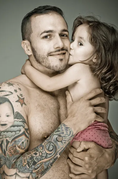 Father and daughter, man with tattoo