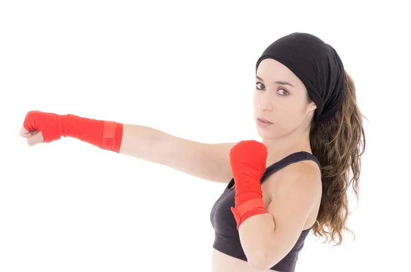 Female mixed martial arts fighter in MMA style gloves strikes a fight stance