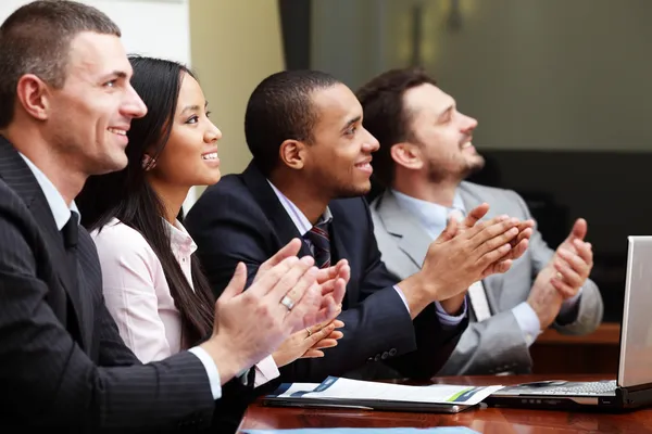 Multi ethnic business group greets somebody