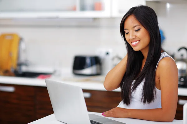 Young beautifu asian woman with laptop at home