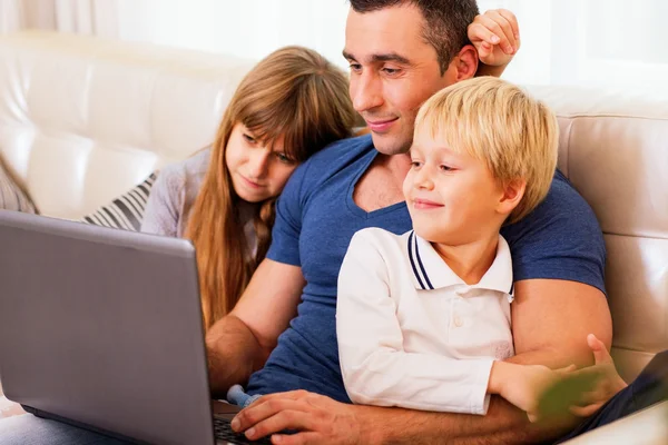 Father with children working on laptop