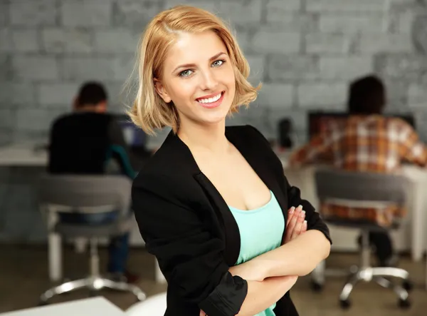 Young beautiful woman in office