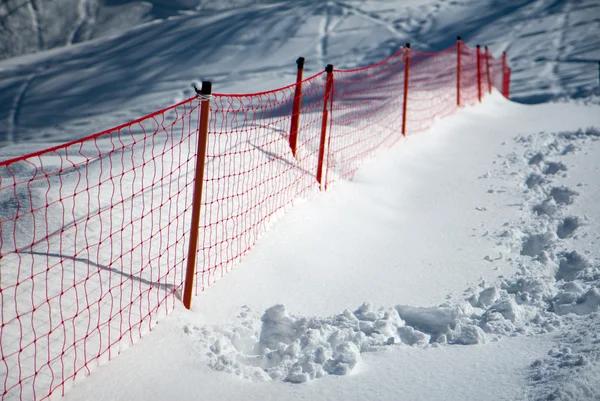 Footprints on the snow slope with the protective screen
