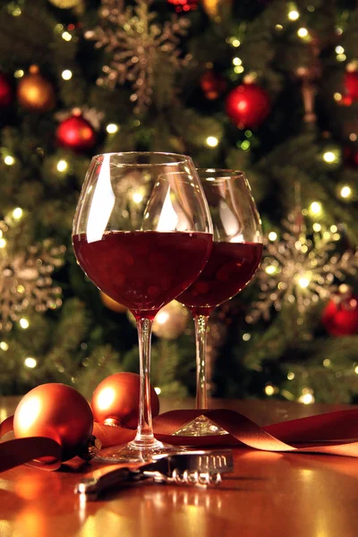 Glasses of wine in front of Christmas tree