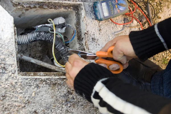 Electrician checks external electrical cable