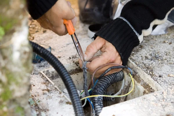 Electrician checks external electrical cable