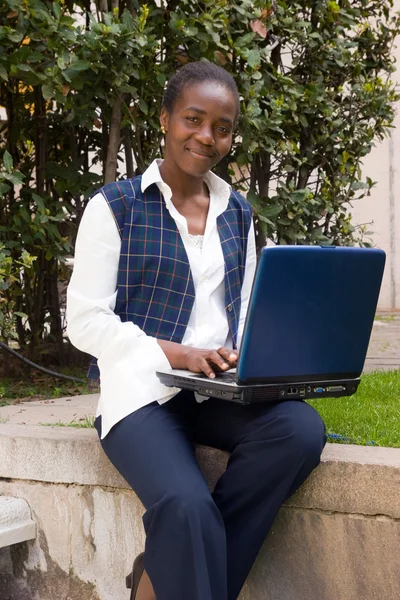 Woman working with laptop outside
