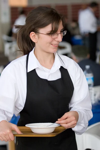 Waitress carries a tray of food