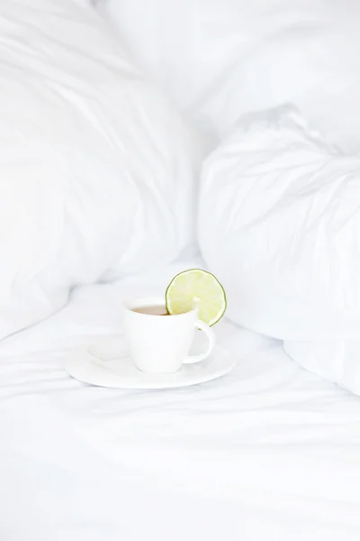 Bed with a pillow and a cup of tea