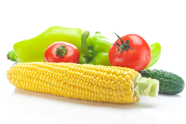 Tomatoes, peppers, cucumbers and corn isolated on white