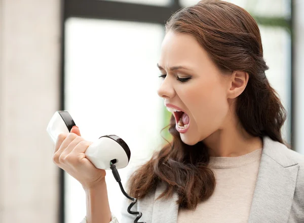 Angry businesswoman shouting at phone