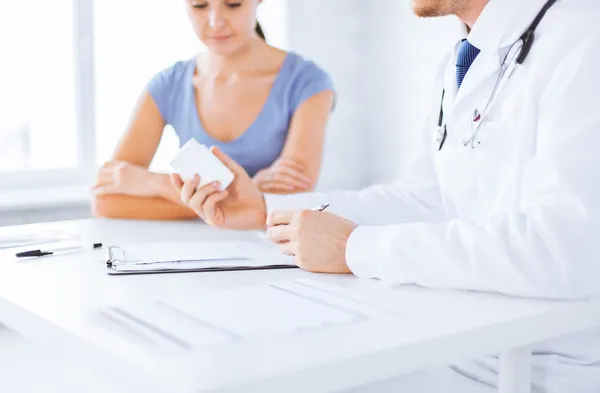 Patient and doctor prescribing medication