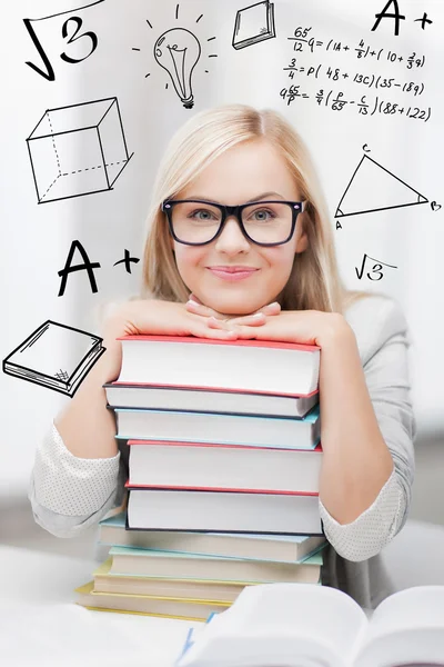 Student with stack of books and doodles