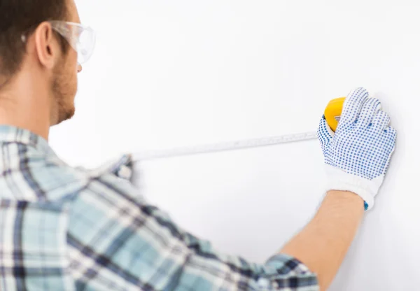 Architect measuring wall with flexible ruler — Stock Photo #30211677