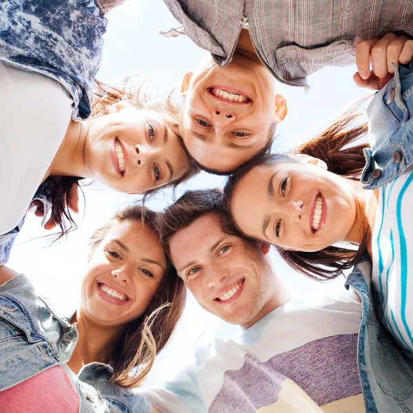 Group of teenagers looking down