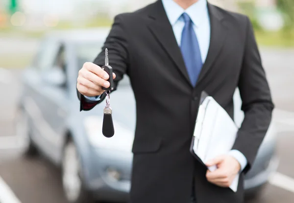 Man with car key outside