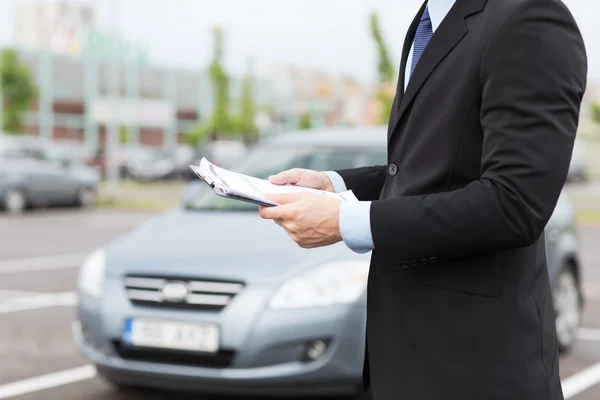 Man with car documents outside — Stock Photo #31504131