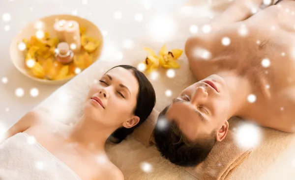 Couple in spa salon lying on the massage desks