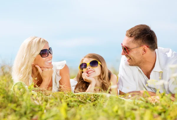 Happy family with blue sky and green grass