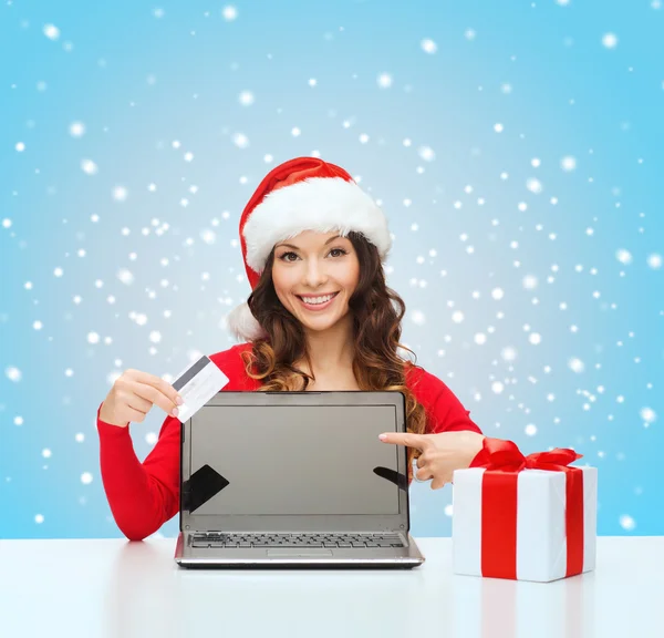 Woman with gift, laptop computer and credit card