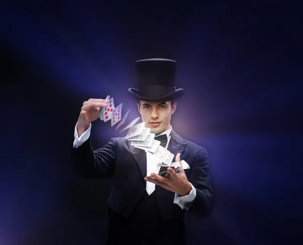 Magician showing trick with playing cards