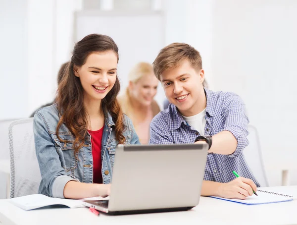 Students with laptop and notebooks at school — Stock Photo #36777239