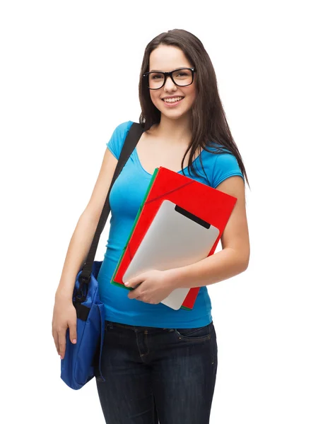 Smiling student with bag, folders and tablet pc