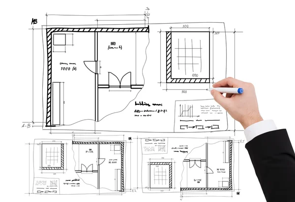 Closeup of businessman hand drawing blueprint
