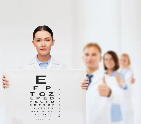 Calm female doctor with eye chart