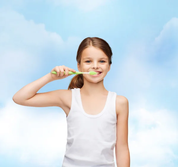 Girl in blank white shirt brushing her teeth