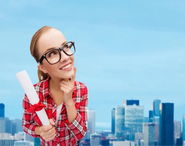 Smiling woman in black eyeglasses with diploma