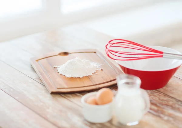 Jugful of milk, eggs in a bowl and flour — Stock Photo #41277705
