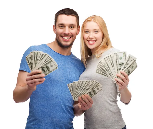 Smiling couple holding dollar cash money