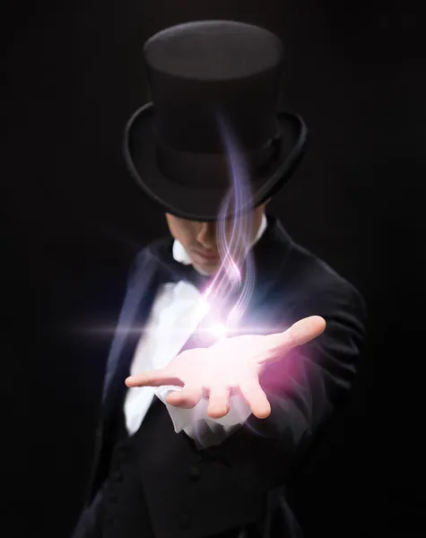 Magician holding something on palm of his hand