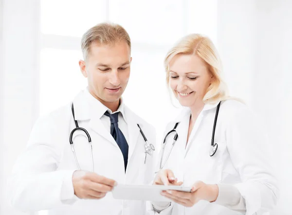 Two doctors looking at tablet pc
