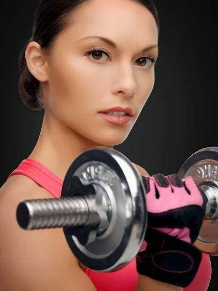 Asian sporty woman with heavy dumbbell
