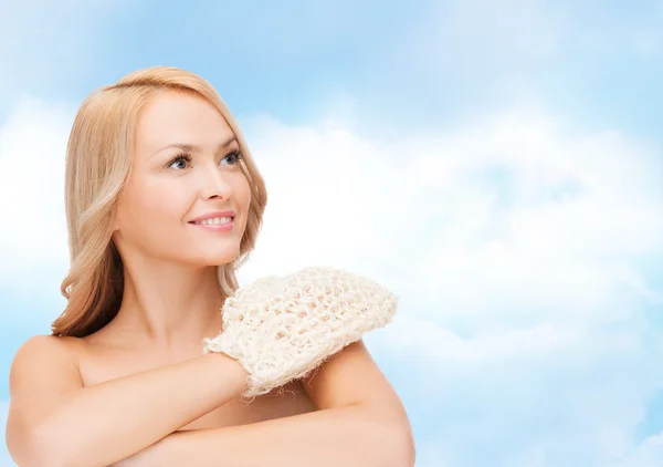 Smiling woman with exfoliation glove